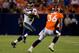 DENVER, CO - AUGUST 18: Quarterback Russell Wilson #3 of the Seattle Seahawks runs for a first down as safety Rafael Bush #36 of the Denver Broncos looks to make a tackle during the fourth quarter at Sports Authority Field Field at Mile High on August 18, 2012 in Denver, Colorado. The Seahawks defeated the Broncos 30-10. (Photo by Justin Edmonds/Getty Images)