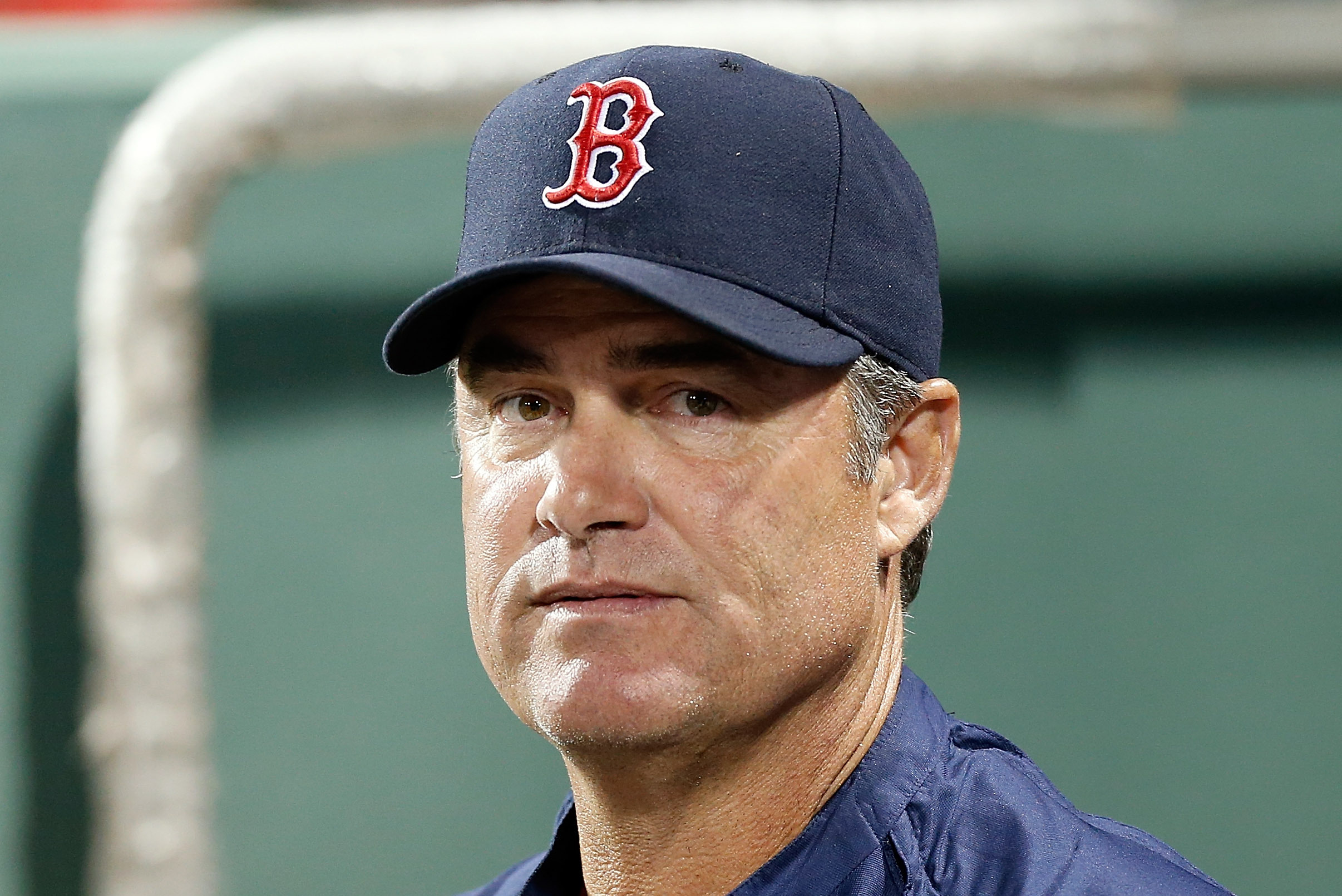 Boston Red Sox pitching coach John Farrell (C) and catcher Jason