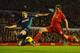 LIVERPOOL, ENGLAND - JANUARY 02: Joe Allen of Liverpool shoots under pressure from Matthew Kilgallon of Sunderland during the Barclays Premier League match between Liverpool and Sunderland at Anfield on January 2, 2013 in Liverpool, England. (Photo by Laurence Griffiths/Getty Images)