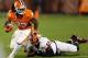 CLEMSON, SC - NOVEMBER 17: Andre Ellington #23 of the Clemson Tigers runs away from Brian Slay #55 of the North Carolina State Wolfpack during their game at Memorial Stadium on November 17, 2012 in Clemson, South Carolina. (Photo by Streeter Lecka/Getty Images)