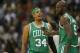 Feb 19, 2013; Denver, CO, USA; Boston Celtics forward Paul Pierce (34) talks with forward Kevin Garnett (5) during the second half against the Denver Nuggets at the Pepsi Center. The Nuggets won 97-90. Mandatory Credit: Chris Humphreys-USA TODAY Sports