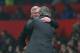 Mourinho and Ferguson embrace each other before their teams' Round of 16 Champions League matchup.