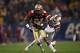 CHARLOTTE, NC - DECEMBER 04: Rodney Smith #84 of the Florida State Seminoles is tackled by Eddie Whitley#15 of the Virginia Tech Hokies during their game at Bank of America Stadium on December 4, 2010 in Charlotte, North Carolina. (Photo by Streeter Lecka/Getty Images)