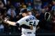 Apr 14, 2013; Seattle, WA, USA; Seattle Mariners relief pitcher Tom Wilhelmsen (54) and Seattle Mariners catcher Jesus Montero (63) hug after defeating the Texas Rangers at Safeco Field. Seattle defeated Texas 4-3. Mandatory Credit: Steven Bisig-USA TODAY Sports