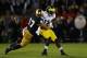 SOUTH BEND, IN - SEPTEMBER 22: Safety Zeke Motta #17 of the Notre Dame Fighting Irish tackles wide receiver Devin Gardner #12 of the Michigan Wolverines in the first quarter at Notre Dame Stadium on September 22, 2012 in South Bend, Indiana. (Photo by Jonathan Daniel/Getty Images)