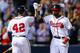 ATLANTA, GA - APRIL 16: Jason Heyward celebrates a solo home run with Justin Upton of the Atlanta Braves in the eighth inning against the Kansas City Royals at Turner Field on April 16, 2013 in Atlanta, Georgia. All uniformed team members are wearing jersey number 42 in honor of Jackie Robinson Day. (Photo by Daniel Shirey/Getty Images)