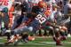 CHAMPAIGN, IL - OCTOBER 15: Braxton Miller #5 of the Ohio State Buckeyes is tackled by Michael Buchanan #99 and Trulon Henry #9 of the Illinois Fighting Illini at Memorial Stadium on October 15, 2011 in Champaign, Illinois. Ohio State defeated Illinois 17-7. (Photo by Jonathan Daniel/Getty Images)