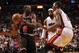 While having a hot hand, Luol Deng faces a double-team from LeBron James and Chris Bosh.