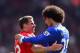 LIVERPOOL, ENGLAND - MAY 05: Jamie Carragher of Liverpool embraces Marouane Fellaini of Everton at the end of the Barclays Premier League match between Liverpool and Everton at Anfield on May 5, 2013 in Liverpool, England. (Photo by Laurence Griffiths/Getty Images)