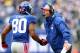 EAST RUTHERFORD, NJ - OCTOBER 07: Head coach Tom Coughlin of the New York Giants congratulates Victor Cruz #80 after Cruz scored a touchdown in the second half against the Cleveland Browns on October 7, 2012 at MetLife Stadium in East Rutherford, New Jersey. (Photo by Elsa/Getty Images)