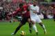 SWANSEA, WALES - DECEMBER 23: Patrice Evra of Manchester United battles with Wayne Routledge of Swansea City during the Barclays Premier League match between Swansea City and Manchester United at the Liberty Stadium on December 23, 2012 in Swansea, Wales. (Photo by Jamie McDonald/Getty Images)