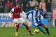WIGAN, ENGLAND - DECEMBER 22: Lukas Podolski of Arsenal competes with Ronnie Stam of Wigan Athletic during the Barclays Premier League match between Wigan Athletic and Arsenal at the DW Stadium on December 22, 2012 in Wigan, England. (Photo by Clive Brunskill/Getty Images)