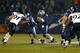 A football game between UConn (blue) and Cincinnati (white)