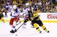 BOSTON, MA - MAY 16: Brad Marchand #63 of the Boston Bruins carries the puck around Michael Del Zotto #4 of the New York Rangers in the first period in Game One of the Eastern Conference Semifinals during the 2013 NHL Stanley Cup Playoffs on May 16, 2013 at TD Garden in Boston, Massachusetts. (Photo by Jared Wickerham/Getty Images)