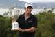 BELFAST, NORTHERN IRELAND - JUNE 22: US Open winning golfer Rory McIlroy poses with his trophy on a green at Holywood Golf Club on June 22, 2011 in Belfast, Northern Ireland. The 22 year old golfer has returned home to his native Northern Ireland and is giving press interviews and meeting with local supporters. (Photo by Peter Macdiarmid/Getty Images)