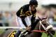 BALTIMORE, MD - MAY 18: Gary Stevens celebrates atop of Oxbow #6 after crossing the finish line to win the 138th running of the Preakness Stakes at Pimlico Race Course on May 18, 2013 in Baltimore, Maryland. (Photo by Patrick Smith/Getty Images)