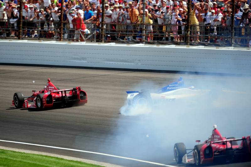 May 27, 2012; Indianapolis, IN, USA; IndyCar driver Dario Franchitti (50) gets past Takuma Sato (15) as Sato crashes into the wall on the last lap of the Indianapolis 500 at the Indianapolis Motor Speedway. Mandatory Credit: Andrew Weber-USA TODAY Sports