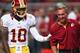 Washington Redskins QB Robert Griffin III and head coach Mike Shanahan enjoy a lighter moment on the Redskins sidelines.