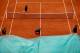 PARIS, FRANCE - MAY 30: Court attendants pull over the covers as rain stops play during day five of the French Open at Roland Garros on May 30, 2013 in Paris, France. (Photo by Matthew Stockman/Getty Images)