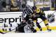 Jun 5, 2013; Boston, MA, USA; A referee breaks up a fight between Boston Bruins center Brad Marchand (63) and Pittsburgh Penguins defenseman Kris Letang (58) during the first overtime period in game three of the Eastern Conference finals of the 2013 Stanley Cup Playoffs at TD Garden. Mandatory Credit: Greg M. Cooper-USA TODAY Sports