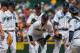 SEATTLE, WA - JUNE 09: Starting pitcher Felix Hernandez #34 of the Seattle Mariners is surrounded by teammates as he pauses on the mound after striking out Chris Stewart of the New York Yankees in the seventh inning at Safeco Field on June 9, 2013 in Seattle, Washington. Hernandez remained in the game after a visit from the trainer. (Photo by Otto Greule Jr/Getty Images)