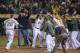 Apr 12, 2013; Oakland, CA, USA; Oakland Athletics third baseman Josh Donaldson (20) celebrates with his teammates after hitting a walk off home run during the twelfth inning against the Detroit Tigers at O.Co Coliseum. The Oakland Athletics defeated the Detroit Tigers 4-3 in extra innings. Mandatory Credit: Ed Szczepanski-USA TODAY Sports