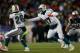 FOXBORO, MA - DECEMBER 30: Ryan Tannehill #17 of the Miami Dolphins hands the ball to Lamar Miller#26 in the second half against the Miami Dolphins at Gillette Stadium on December 30, 2012 in Foxboro, Massachusetts. (Photo by Jim Rogash/Getty Images)