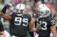 Oct 21, 2012; Oakland, CA, USA; Oakland Raiders defensive end Lamarr Houston (99) flexes after making a tackle as safety Tyvon Branch (33) watches during the game against the Jacksonville Jaguars at O.co Coliseum. Mandatory Credit: Kirby Lee/Image of Sport-USA TODAY Sports