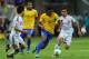 BRASILIA, BRAZIL - JUNE 15: Paulinho of Brazil competes with Yasuyuki Konno and Yuto Nagatomo (r) of Japan during the FIFA Confederations Cup Brazil 2013 Group A match between Brazil and Japan at National Stadium on June 15, 2013 in Brasilia, Brazil. (Photo by Clive Rose/Getty Images)