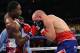 Feb 16, 2013; Atlantic City, NJ, USA; Adrien Broner (Red trunks) and Gavin Rees (Blue/Red trunks) trade punches during their 12 round WBC Lightweight Championship bout at Boardwalk Hall. Mandatory Credit: Ed Mulholland-USA TODAY Sports