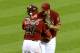 PHOENIX, AZ - JUNE 19: Heath Bell #21 and teammate Miguel Montero #26 of the Arizona Diamondbacks celebrate a win against the Miami Marlins at Chase Field on June 19, 2013 in Phoenix, Arizona. Arizona won 3-1. (Photo by Norm Hall/Getty Images)