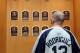 COOPERSTOWN, NY - JULY 24: A patron of the Baseball Hall of Fame and Museum views the plaques of inducted members during induction weekend on July 24, 2010 in Cooperstown, New York. (Photo by Jim McIsaac/Getty Images)
