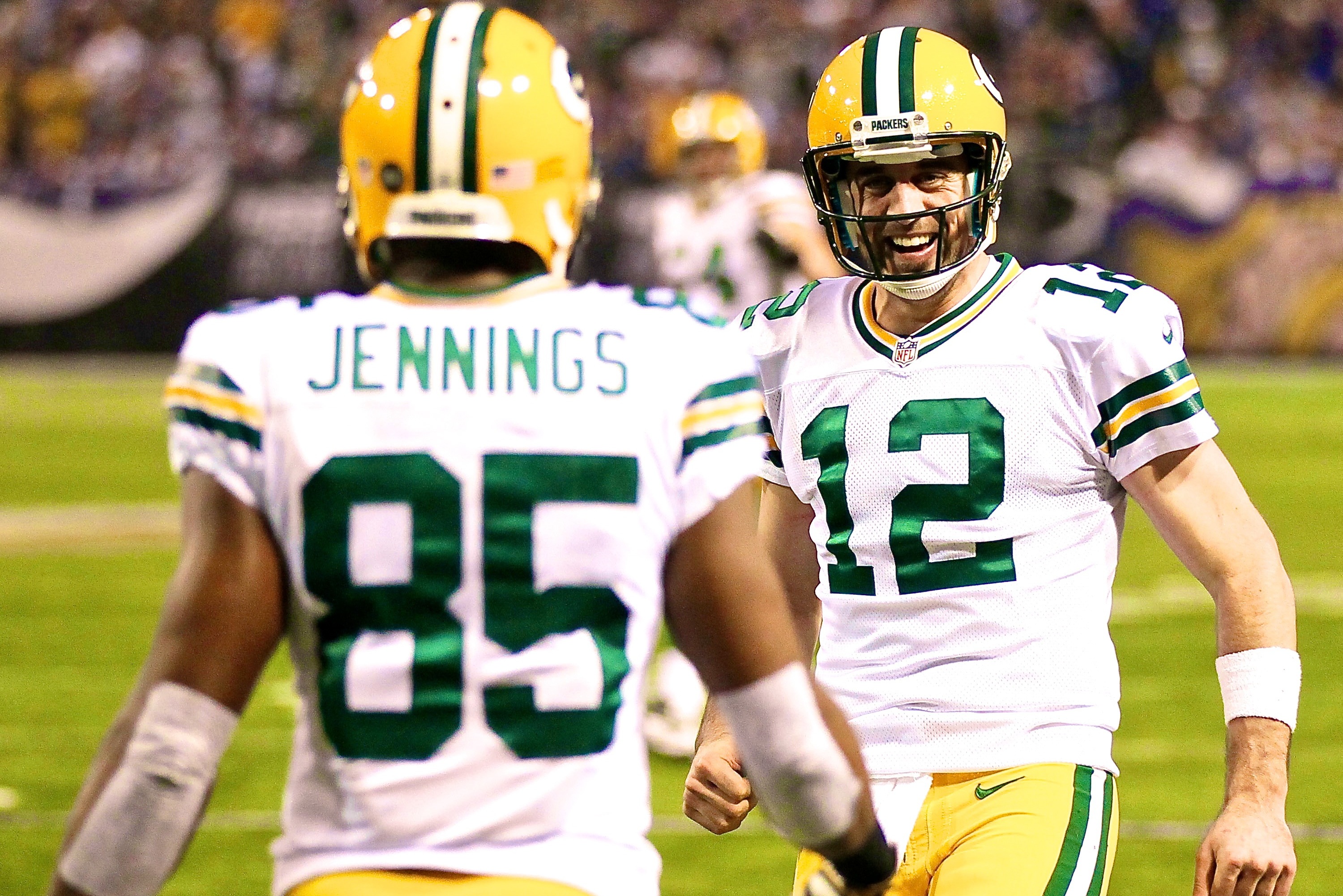 Nov 21, 2010; Minneapolis, MN, USA; Green Bay Packers wide receiver Greg Jennings (85) celebrates his 22-yard touchdown with quarterback Aaron Rodgers (12) against the Minnesota Vikings in the fourth quarter at the Metrodome. The Packers win 31-3. Mandatory Credit: Bruce Kluckhohn-USA TODAY Sports