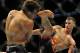 Jul 27, 2013; Seattle, WA, USA; Rory MacDonald (red tape) lands a kick to the head of Jake Ellenberger (blue tape) during their welterweight bout at Key Arena. McDonald won by a decision. Mandatory Credit: Jayne Kamin-Oncea-USA TODAY Sports