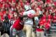 September 8, 2012; Columbus, OH, USA; Ohio State Buckeyes defensive lineman Adolphus Washington (92) hits UCF Knights quarterback Blake Bortles (5) as he releases the ball at Ohio Stadium. Ohio State won the game 31-16. Mandatory Credit: Greg Bartram-USA TODAY Sports