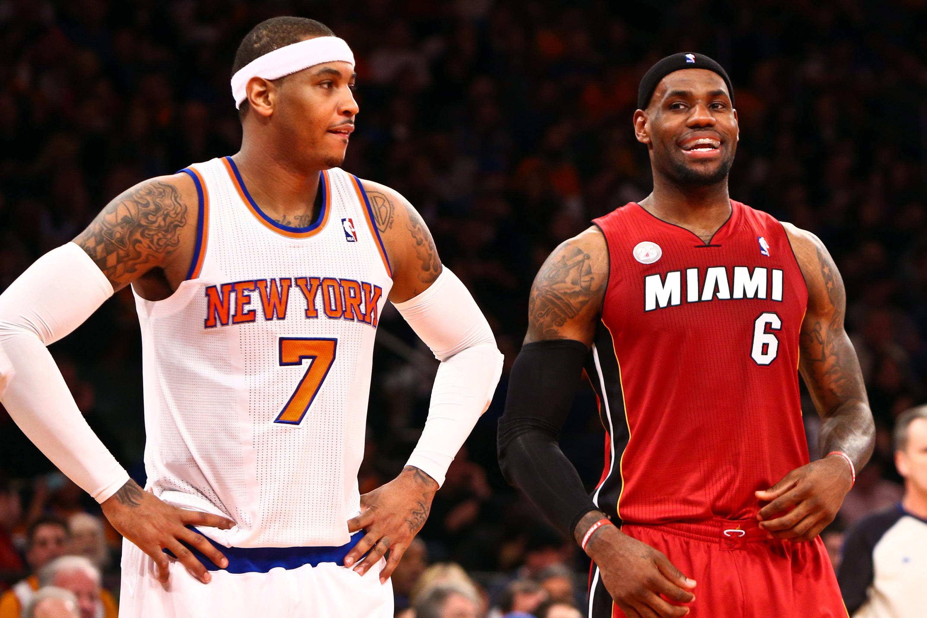 Miami Heat's LeBron James sits between the Larry O'Brien NBA