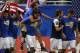 Stuart Holden celebrates the Gold Cup win on the back of Omar Gonzalez