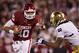 NORMAN, OK - OCTOBER 27: Blake Bell #10 of the Oklahoma Sooners avoids the tackle of Ishaq Williams #11 of the Notre Dame Fighting Irish on his way to a touchdown at Gaylord Family Oklahoma Memorial Stadium on October 27, 2012 in Norman, Oklahoma. The Fighting Irish defeated the Sooners 30-13. (Photo by Wesley Hitt/Getty Images)