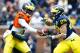 Apr 13, 2013; Ann Arbor, MI, USA; Michigan Wolverines quarterback Devin Gardner (12) hands off to running back Drake Johnson (29) during the Spring Game at Michigan Stadium. Mandatory Credit: Rick Osentoski-USA TODAY Sports