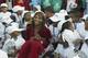Serena Williams sits among children at 2003 tennis event.