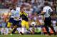 LONDON, ENGLAND - AUGUST 25: Pablo Hernandez of Swansea passes the ball as Nacer Chadli of Spurs closes in during the Barclays Premier League match between Tottenham Hotspur and Swansea City at White Hart Lane on August 25, 2013 in London, England. (Photo by Michael Regan/Getty Images)
