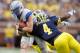 ANN ARBOR, MI - SEPTEMBER 08: Connor Dietz #11 of the Air Force Falcons tries to get around the tackle of Cameron Gordon #4 of the Michigan Wolverines during a fourth quarter run at Michigan Stadium on September 8, 2012 in Ann Arbor, Michigan. Michigan won the game 31-25. (Photo by Gregory Shamus/Getty Images)