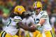ST. LOUIS, MO - AUGUST 17: Aaron Rodgers #12 of the Green Bay Packershands the ball off to Eddie Lacy #27 of the Green Bay Packers during a preseason game against the St. Louis Rams at the Edward Jones Dome on August 17, 2013 in St. Louis, Missouri. (Photo by Dilip Vishwanat/Getty Images)