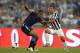 ROME, ITALY - AUGUST 18: Carlos Tevez of FC Juventus and Andre Dias of SS Lazio (L) compete for the ball during the TIM Supercup match between SS Lazio and FC Juventus at Olimpico Stadium on August 18, 2013 in Rome, Italy. (Photo by Claudio Villa/Getty Images)
