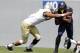 Aug 31, 2013; Morgantown, WV, USA; West Virginia Mountaineers running back Charles Sims (3) carries the ball as William & Mary Tribe linebacker Quincey September (9) defends during the second quarter at Milan Puskar Stadium. The West Virginia Mountaineers won 24-17. Mandatory Credit: Charles LeClaire-USA TODAY Sports