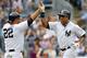 NEW YORK, NY - SEPTEMBER 2: Curtis Granderson #14 of the New York Yankees is congratulated by Vernon Wells #22 who both scored on a single by Austin Romine #53 in the fourth inning against the Chicago White Sox in a MLB baseball game at Yankee Stadium on September 2, 2013 in the Bronx borough of New York City. (Photo by Rich Schultz/Getty Images)