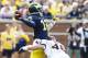 Aug 31, 2013; Ann Arbor, MI, USA; Michigan Wolverines quarterback Devin Gardner (12) is hit by Central Michigan Chippewas defensive end Blake Serpa (46) just as he passes the ball second quarter at Michigan Stadium. Mandatory Credit: Rick Osentoski-USA TODAY Sports