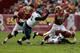 WASHINGTON, DC - NOVEMBER 18: Quarterback Robert Griffin III #10 of the Washington Redskins eludes the tackle of defensive tackle Fletcher Cox #91 of the Philadelphia Eagles at FedEx Field on November 18, 2012 in Washington, DC. (Photo by Rob Carr/Getty Images)