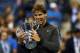 NEW YORK, NY - SEPTEMBER 09: Rafael Nadal of Spain bites the US Open Championship trophy as he celebrates winning the men's singles final match against Novak Djokovic of Serbia on Day Fifteen of the 2013 US Open at the USTA Billie Jean King National Tennis Center on September 9, 2013 in the Flushing neighborhood of the Queens borough of New York City. (Photo by Elsa/Getty Images)