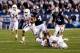 Sep 7, 2013; Provo, UT, USA; Brigham Young Cougars quarterback Taysom Hill (4) breaks tackles from Texas Longhorns safety Josh Turner (5) and Texas Longhorns cornerback Sheroid Evans (29) scores a touchdown at Lavell Edwards Stadium. Mandatory Credit: Chris Nicoll-USA TODAY Sports